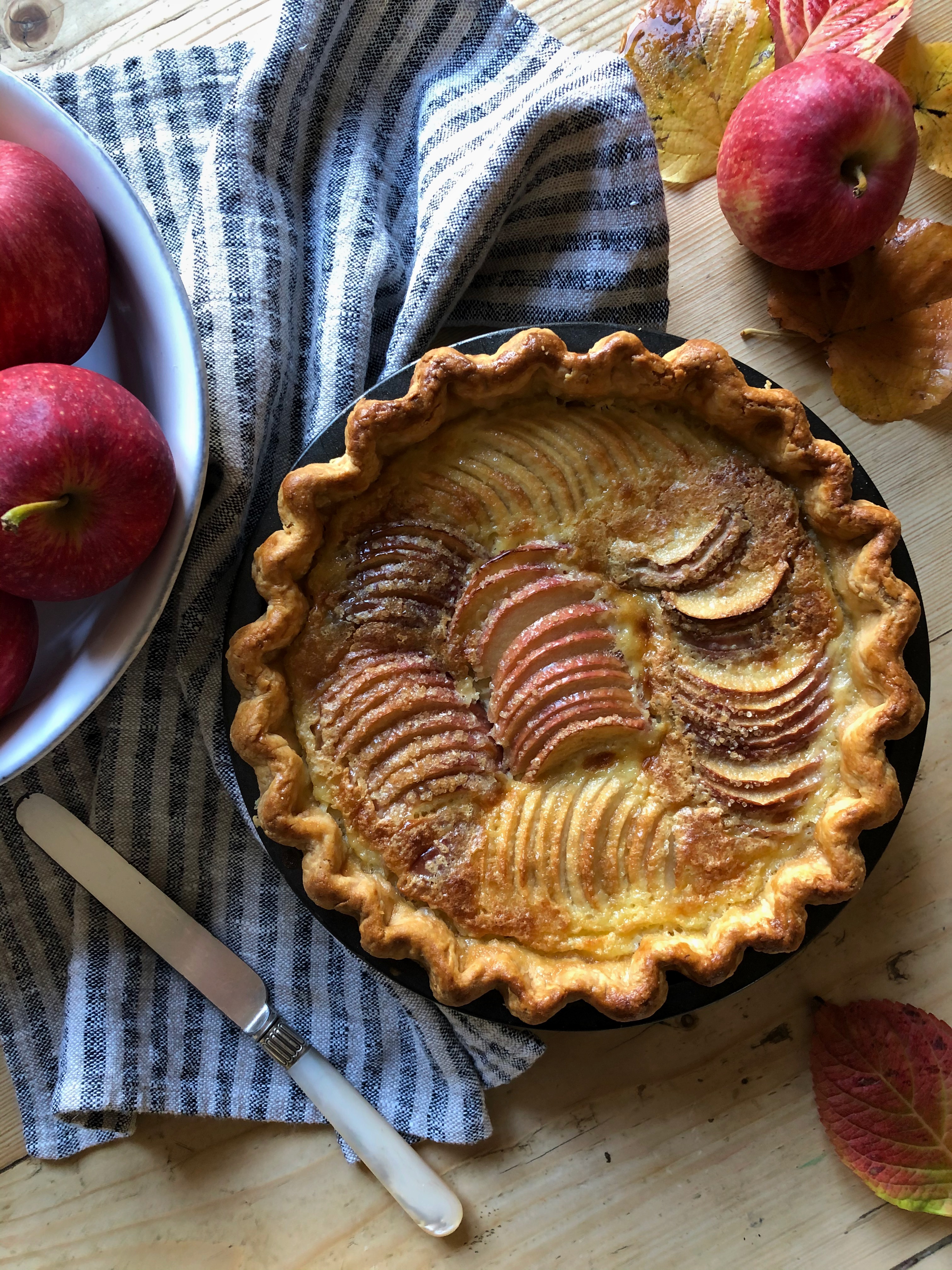 Apple tart normande - a crisp pastry tart filled with apples and a calvados spiked custards
